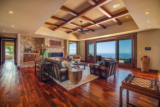 living room with a water view, a fireplace, coffered ceiling, and dark hardwood / wood-style flooring