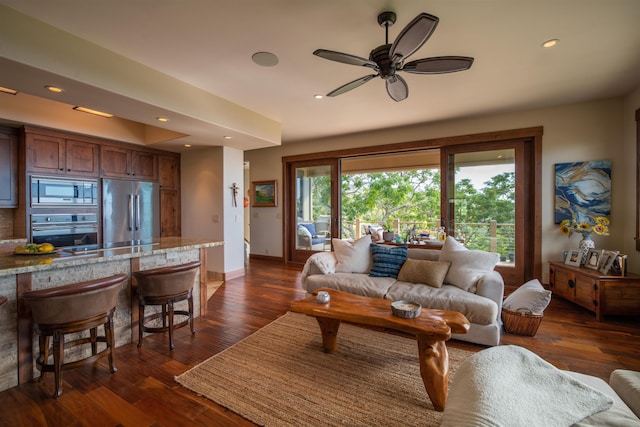 living room featuring dark hardwood / wood-style floors and ceiling fan