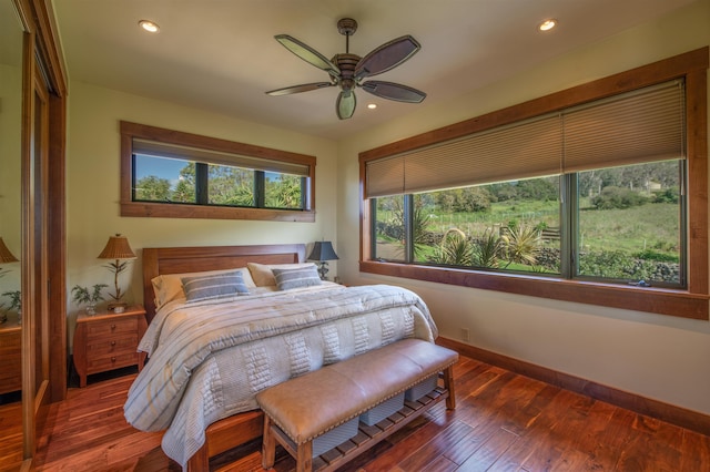 bedroom with ceiling fan and dark hardwood / wood-style flooring