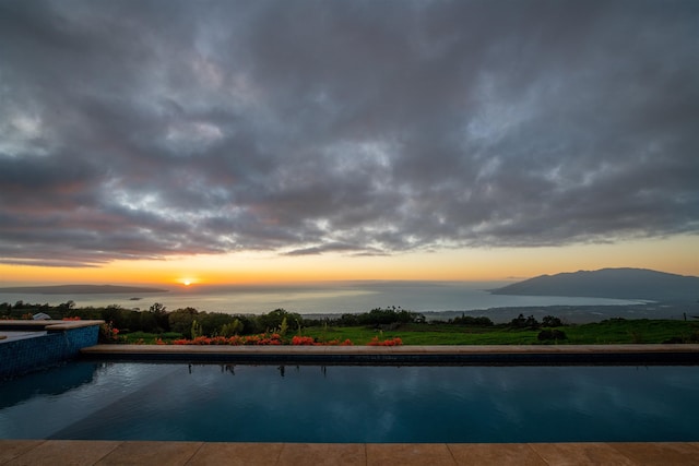 pool at dusk with a mountain view