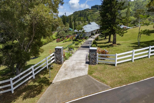 view of property's community featuring a rural view and a lawn