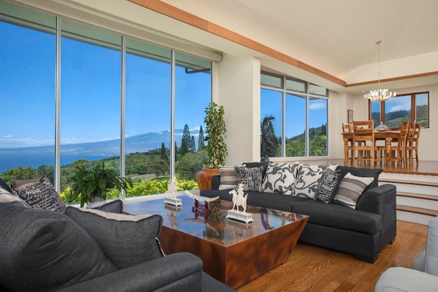 living room featuring a mountain view, wood-type flooring, and a notable chandelier