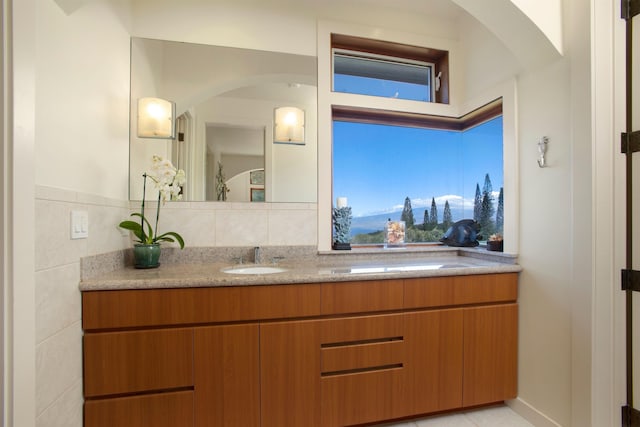 bathroom with tile patterned flooring, backsplash, and vanity