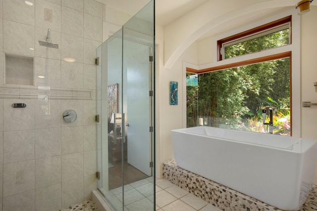 bathroom featuring a healthy amount of sunlight, tile patterned flooring, and independent shower and bath