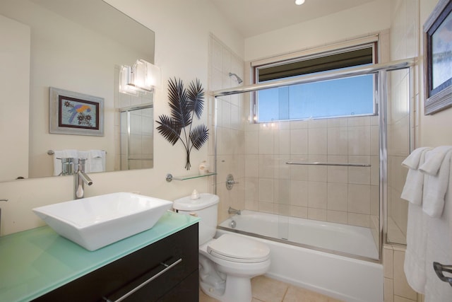 full bathroom with toilet, combined bath / shower with glass door, tile patterned flooring, and vanity