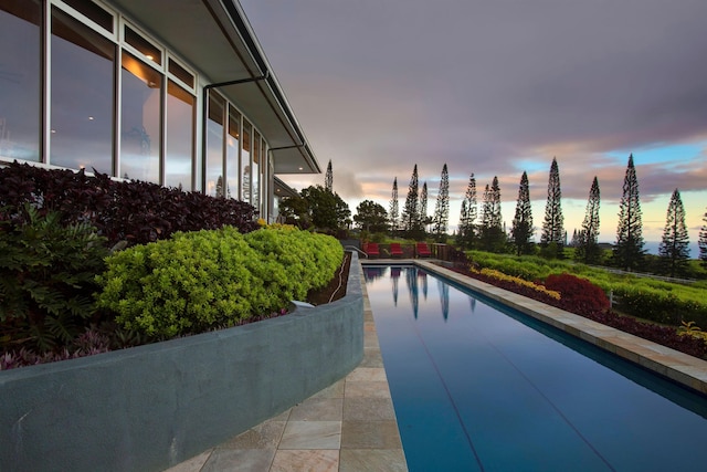 view of pool at dusk