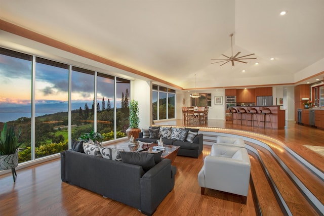 living room with wood-type flooring, vaulted ceiling, and sink