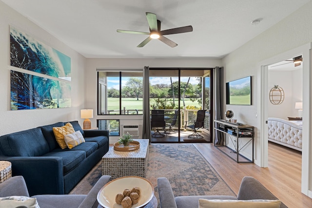 living room featuring light hardwood / wood-style flooring and ceiling fan