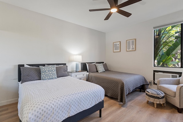 bedroom with hardwood / wood-style floors and ceiling fan