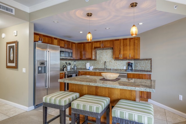 kitchen with brown cabinets, light tile patterned flooring, visible vents, and appliances with stainless steel finishes