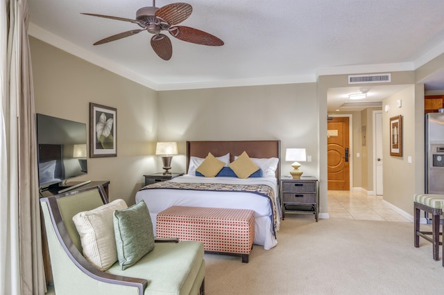 carpeted bedroom featuring visible vents, a ceiling fan, ornamental molding, and baseboards