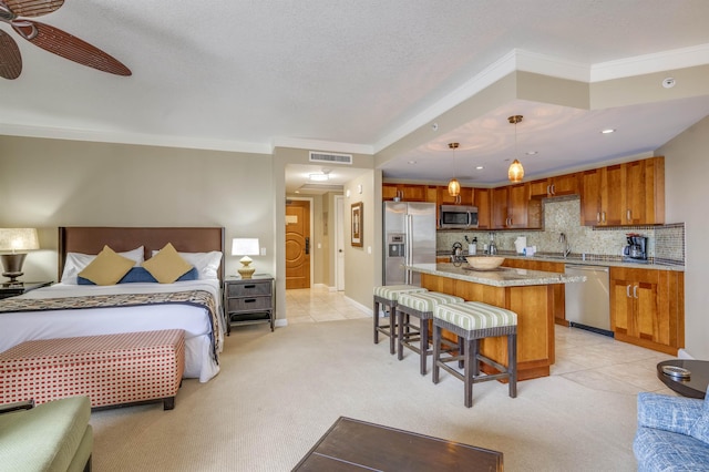 bedroom with light colored carpet, stainless steel fridge, a sink, visible vents, and crown molding