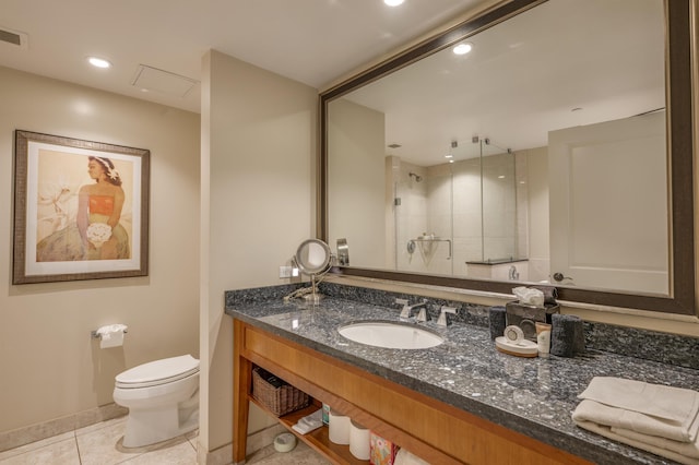bathroom with a tile shower, tile patterned flooring, toilet, vanity, and baseboards