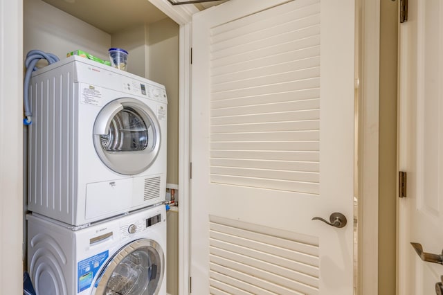 laundry room featuring stacked washer and dryer and laundry area