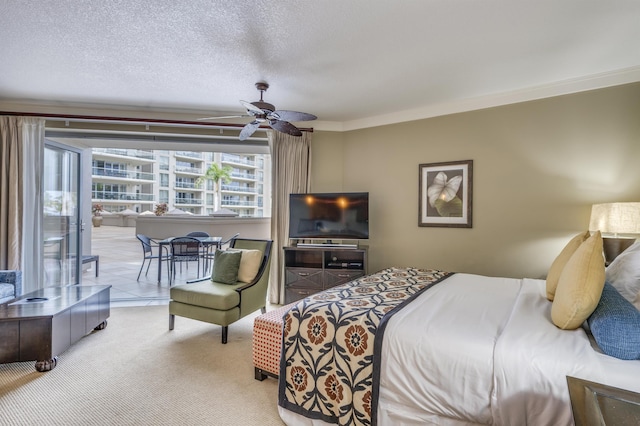 bedroom featuring carpet, a ceiling fan, ornamental molding, and a textured ceiling