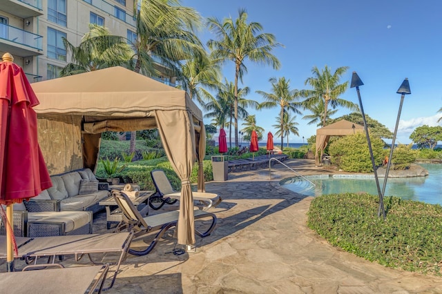 exterior space featuring an outdoor living space, a gazebo, and a community pool