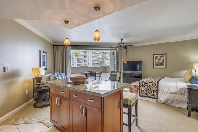 kitchen featuring ceiling fan, a center island, a breakfast bar, light carpet, and open floor plan