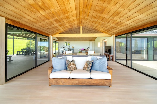 sunroom featuring wooden ceiling and a healthy amount of sunlight