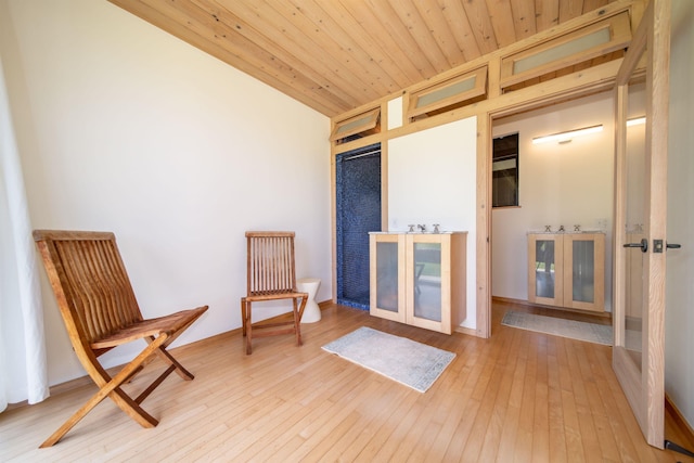 living area featuring wood ceiling and light hardwood / wood-style flooring