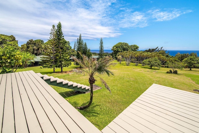 wooden deck with a water view and a lawn