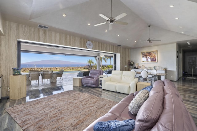 living room with ceiling fan, vaulted ceiling, and plenty of natural light