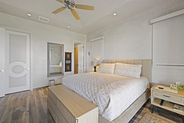 bedroom with ceiling fan and dark hardwood / wood-style floors