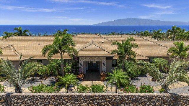 exterior space with a water and mountain view