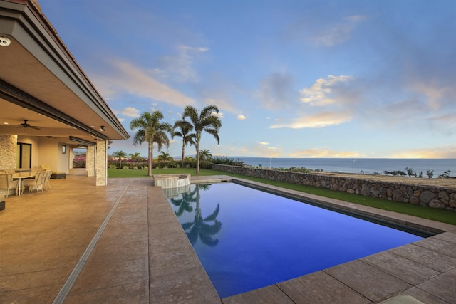 view of pool featuring a water view, ceiling fan, and a patio