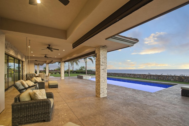 view of patio featuring a swimming pool with hot tub, ceiling fan, an outdoor living space, and a water view