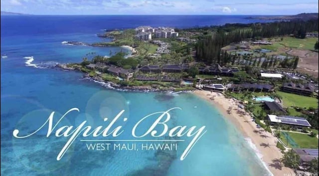 birds eye view of property featuring a beach view and a water view