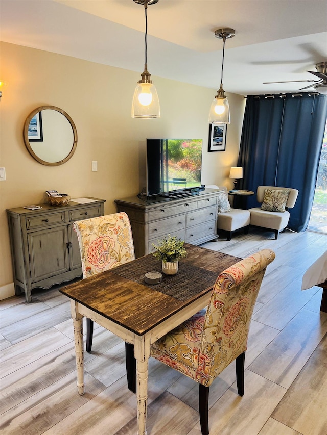 dining room with light wood-style flooring and a ceiling fan