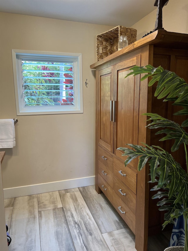 interior space with baseboards and wood finished floors