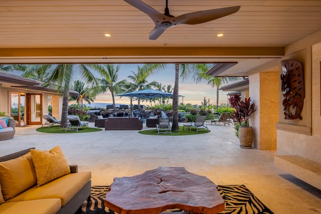 34 Ualei Pl, Kihei, HI 96753 - patio terrace at dusk with french doors, a ceiling fan, and an outdoor hangout area
