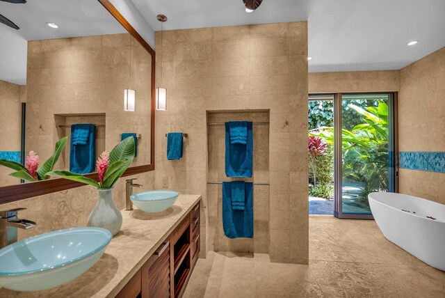 34 Ualei Pl, Kihei, HI 96753 - full bath featuring tile walls, a sink, double vanity, and a soaking tub