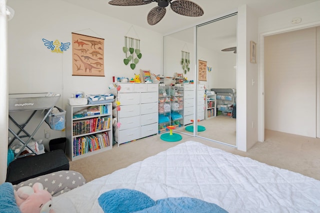 bedroom featuring ceiling fan, a closet, and carpet flooring
