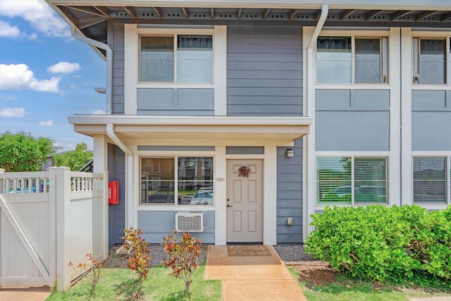 property entrance featuring fence and a porch