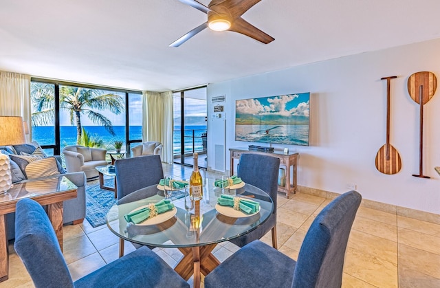 dining space featuring baseboards, floor to ceiling windows, a ceiling fan, and tile patterned floors