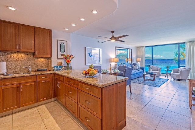 kitchen with brown cabinets, a sink, and decorative backsplash