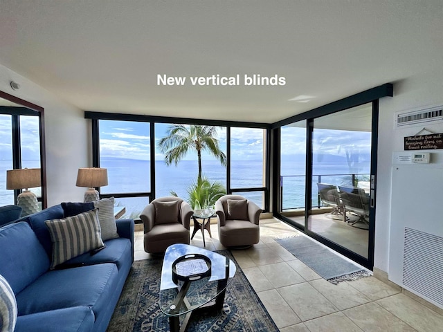 living room featuring expansive windows, light tile patterned floors, and plenty of natural light