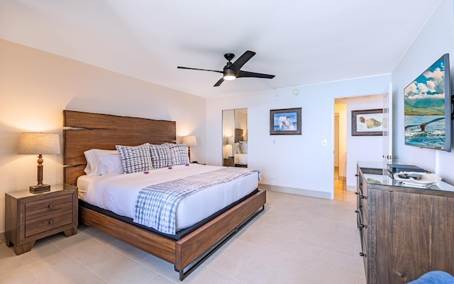 bedroom with ceiling fan, a closet, and baseboards