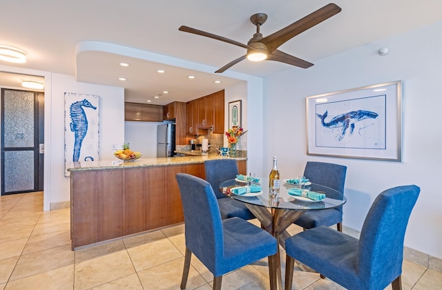 dining area with light tile patterned floors, baseboards, a ceiling fan, and recessed lighting