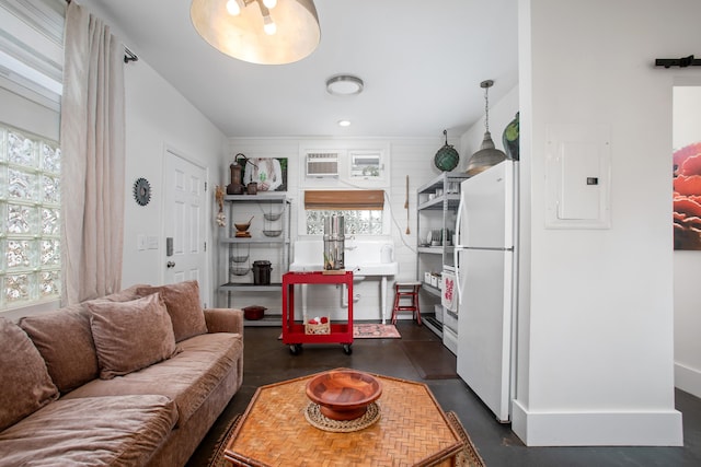 living room with electric panel, a healthy amount of sunlight, and a wall mounted air conditioner