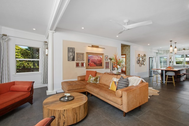 living room with ceiling fan, ornate columns, and crown molding