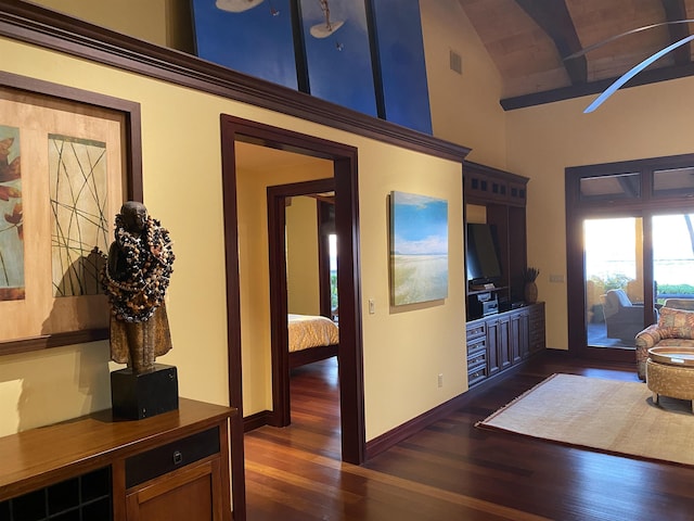 living room featuring high vaulted ceiling, dark wood finished floors, visible vents, and baseboards