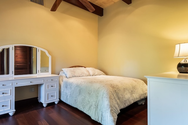 bedroom with ceiling fan, dark wood-style flooring, visible vents, beam ceiling, and built in desk