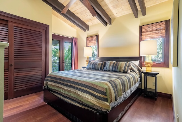 bedroom featuring lofted ceiling with beams, wood finished floors, wood ceiling, and baseboards