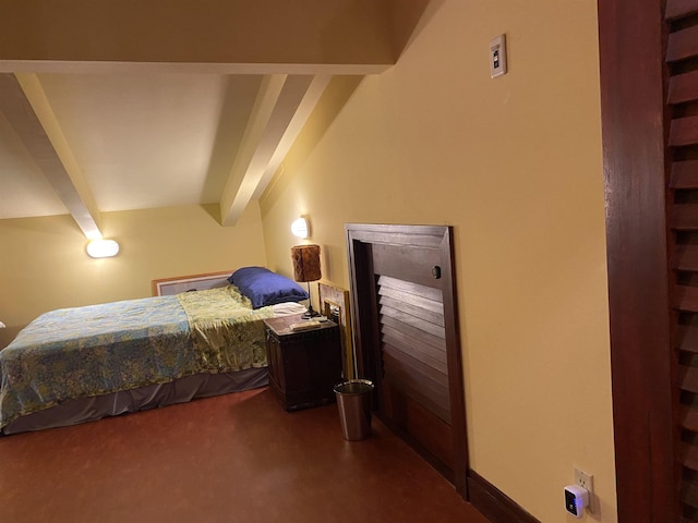 bedroom with dark carpet and beam ceiling