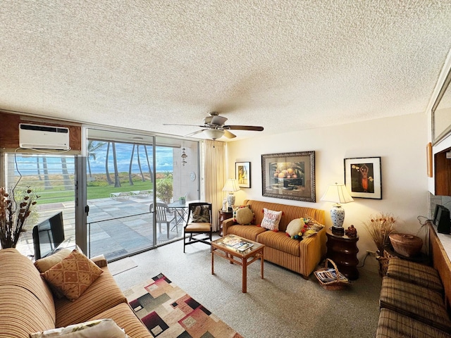 carpeted living room featuring a wall mounted air conditioner, ceiling fan, and a textured ceiling