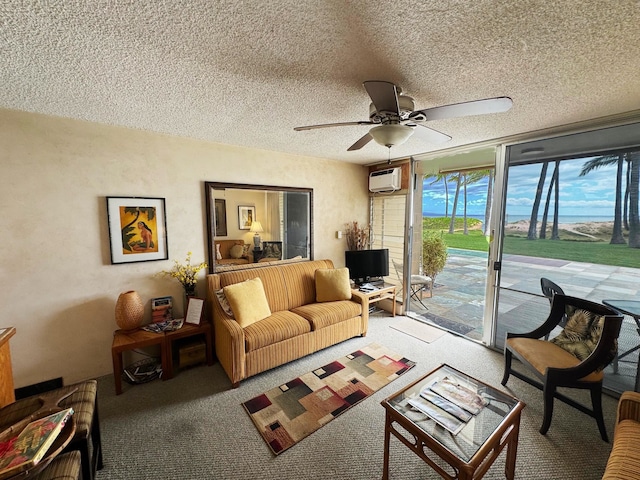 living room featuring ceiling fan, an AC wall unit, carpet floors, and a textured ceiling