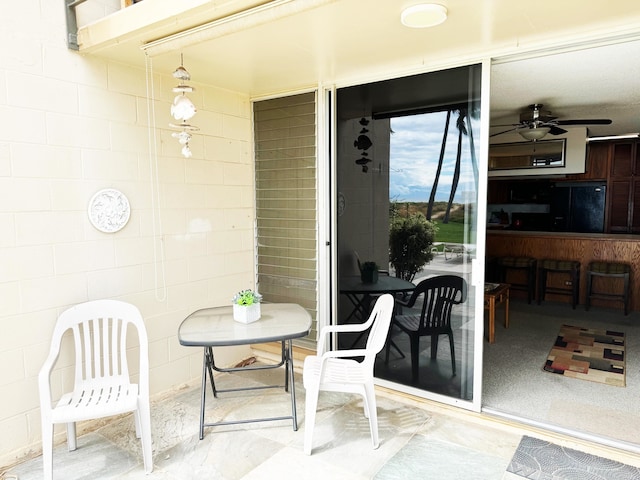 exterior space featuring ceiling fan